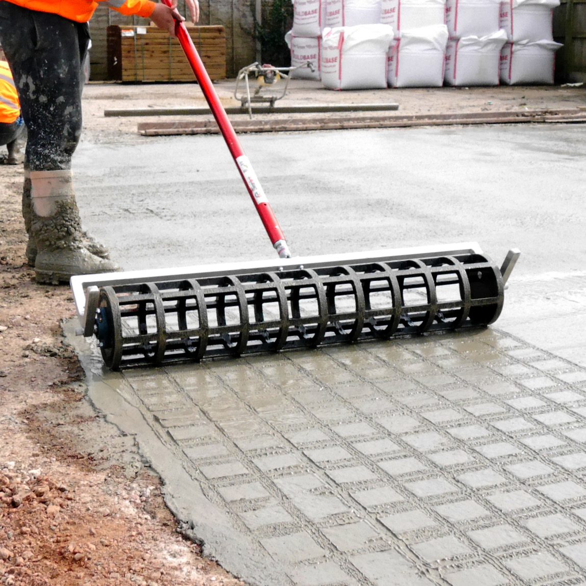 Concrete pattern roller from Speedcrete creates squares in the concrete for yards and agricultural shed floors.